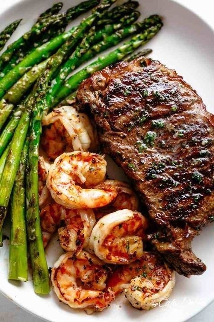 AI caption: steak and shrimp on a plate, black and white