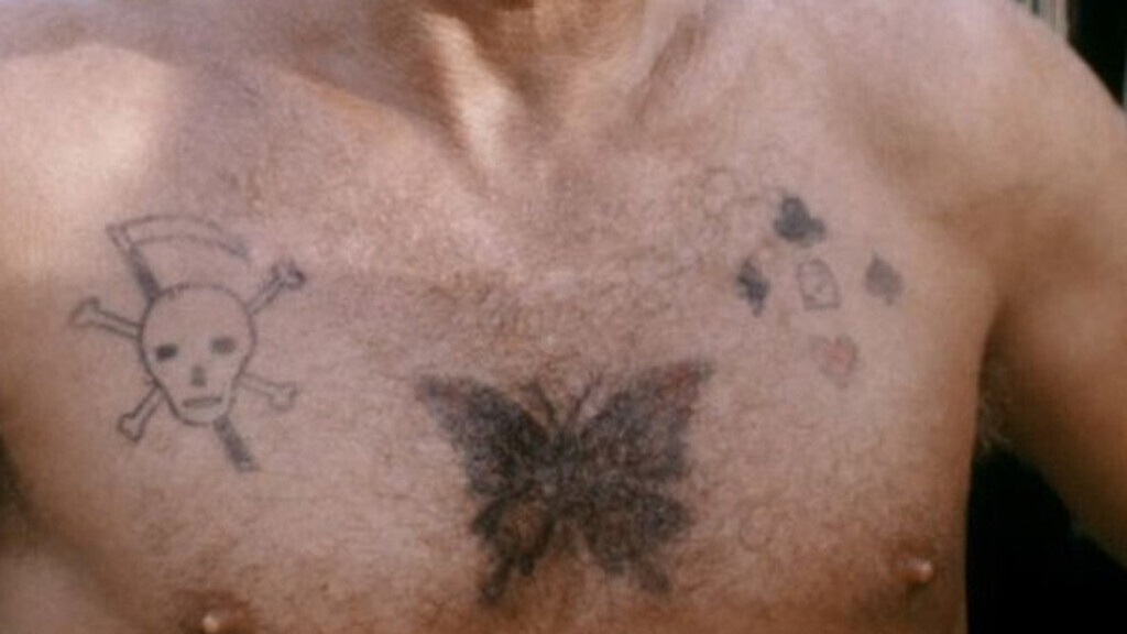 AI caption: a man with a tattoo on his chest, tattoo