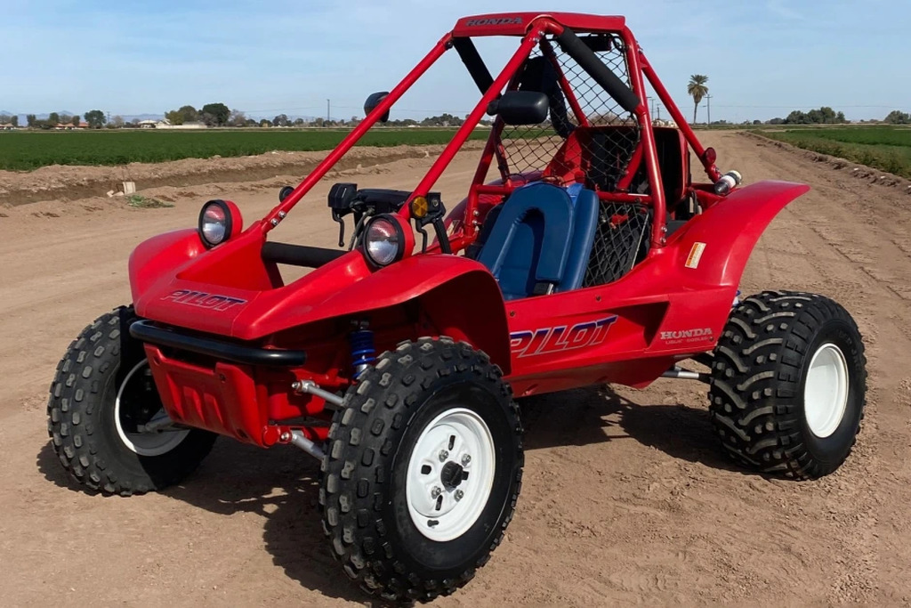 AI caption: a red dune buggy is parked in a field, b&w