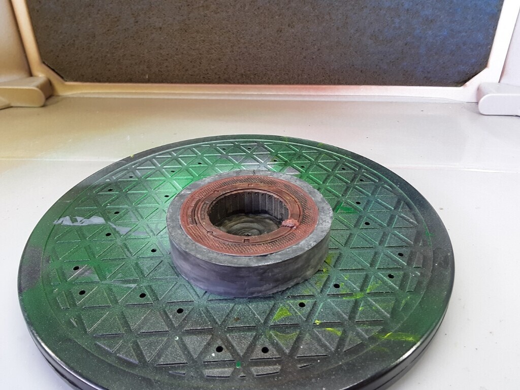 AI caption: a green disc with a hole in it, flat