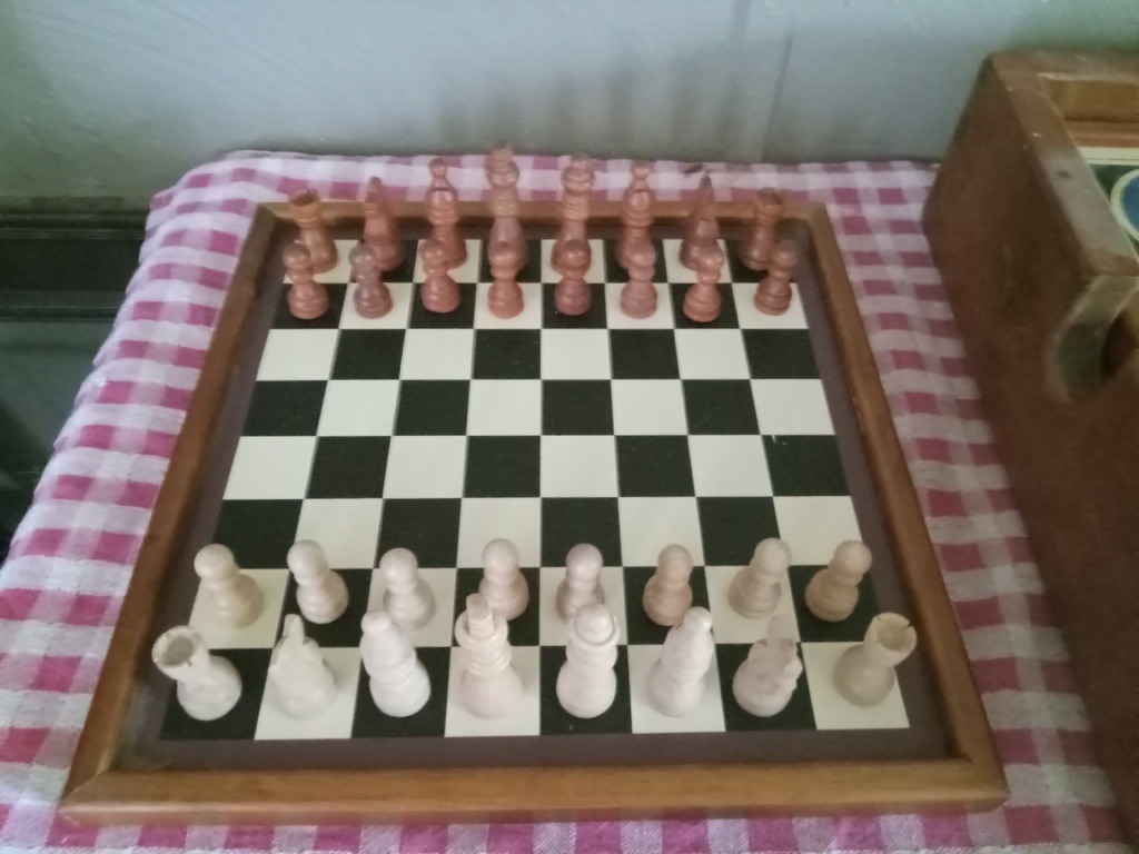 AI caption: a wooden chess set with a wooden box, vintage