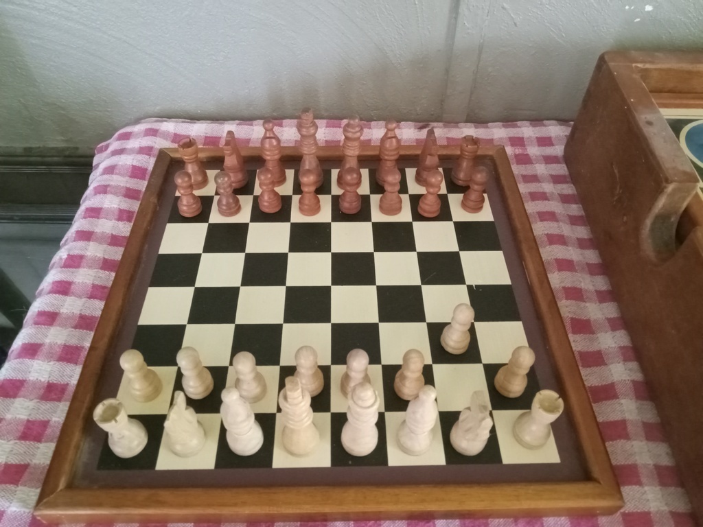 AI caption: a wooden chess set with a wooden box, vintage