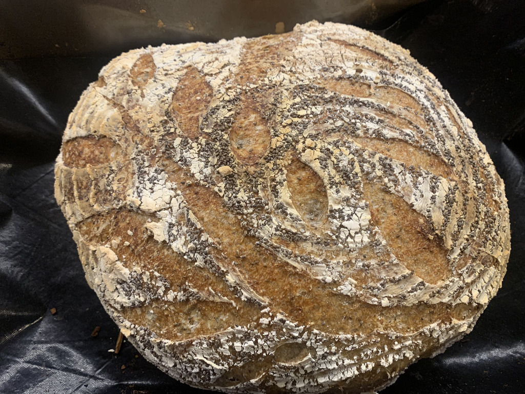 AI caption: a loaf of bread sitting on a black cloth, a close up of a loaf of bread