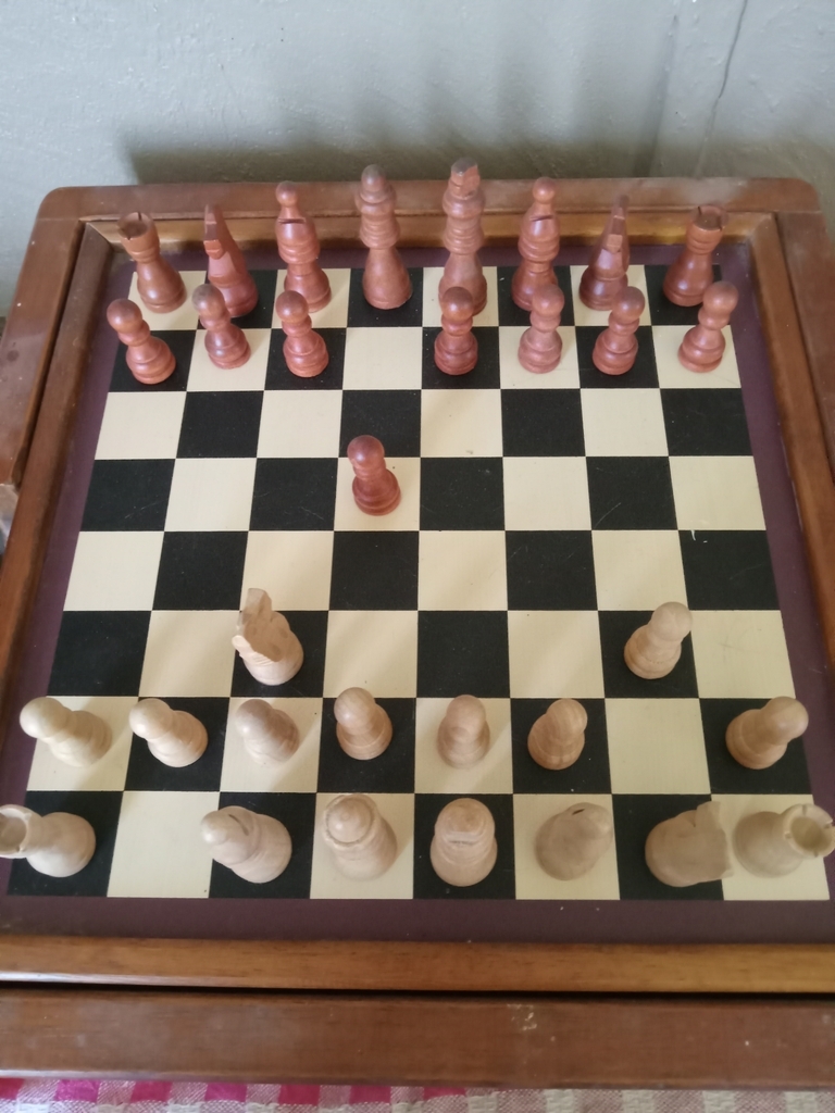 AI caption: a wooden chess board with wooden pieces, black and white