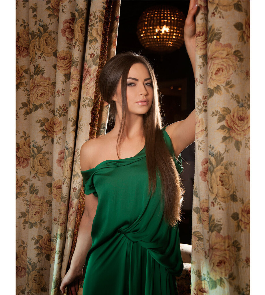 AI caption: a beautiful blonde woman in a white dress posing on a railing, portrait a young woman in a green dress posing in front of a fountain, the girl is wearing a green dress, portrait a woman in a black jacket is standing in a stadium, the girl is wearing a hat, portrait a woman in a green dress posing in front of a curtain, the woman is posing in front of a curtain, portrait