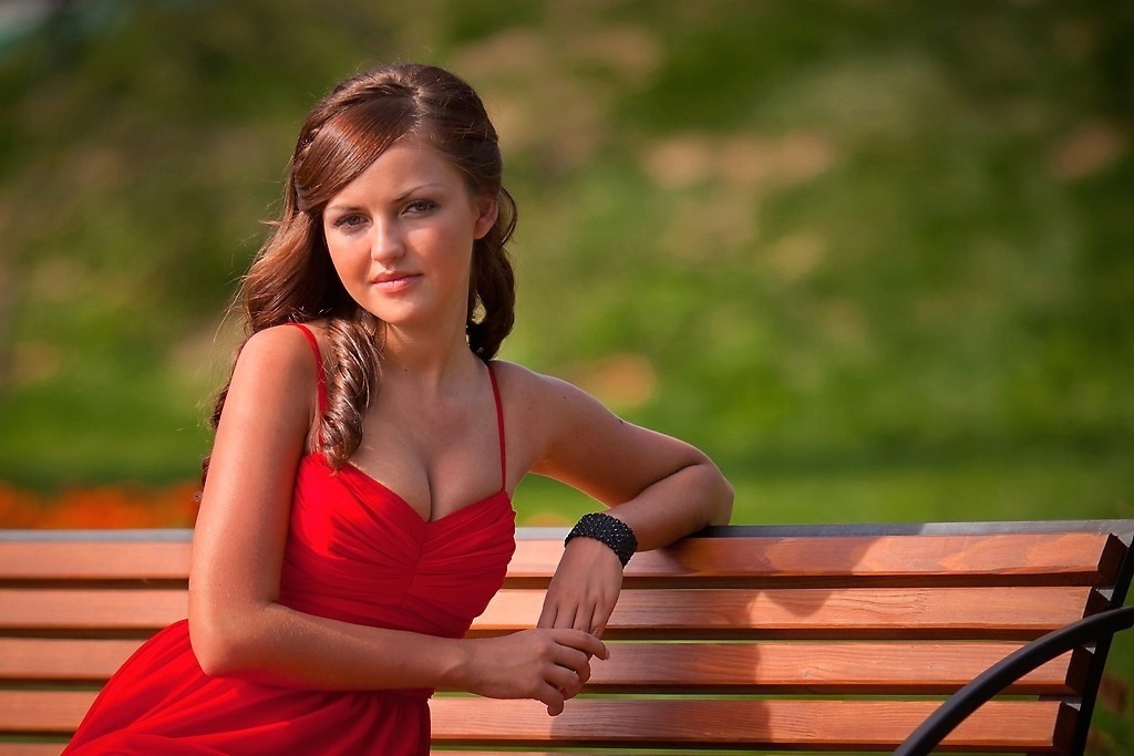 AI caption: a woman in a blue shirt, portrait a beautiful woman in a black dress posing for a picture, the girl is posing in a black dress, portrait a young woman is leaning against a tree, the girl is posing in a tree, portrait a beautiful woman in a red dress sitting on a wooden bench, the girl is too beautiful, portrait