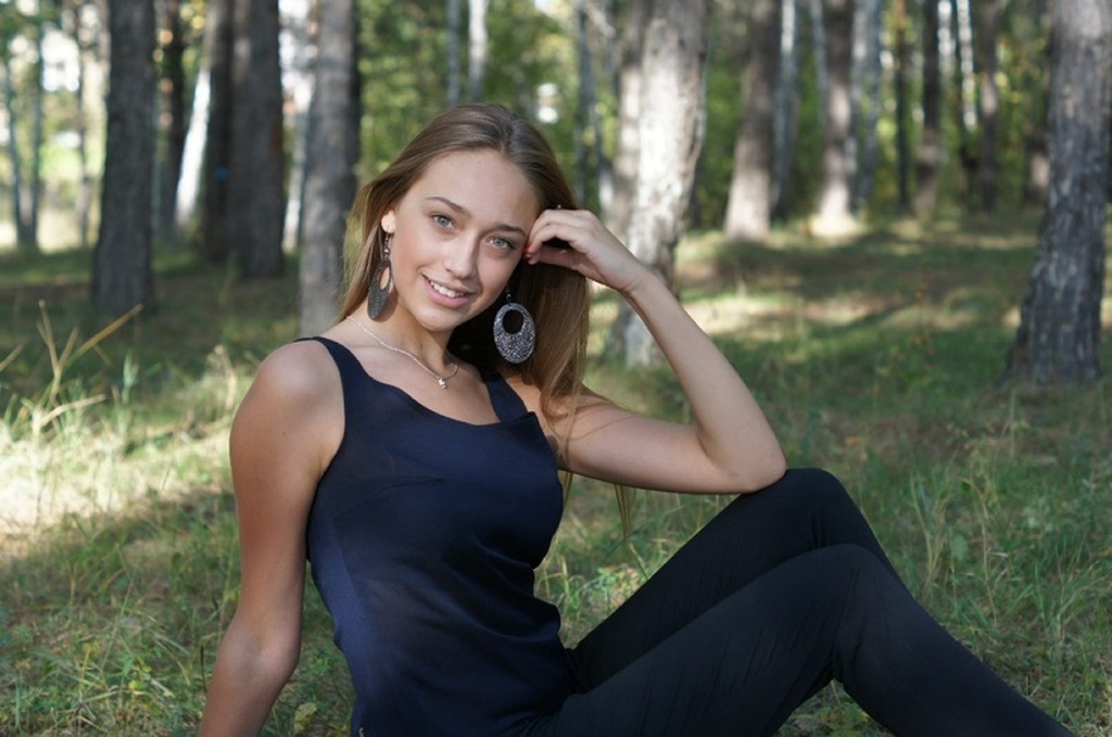 AI caption: a beautiful woman sitting on a bus, portrait a beautiful woman sitting on the ground in the forest